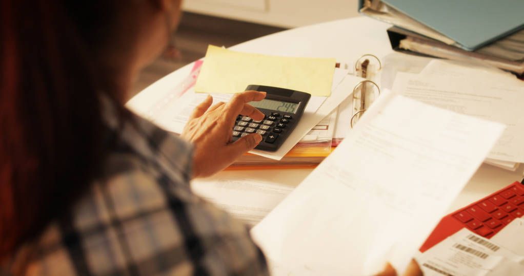 Elderly Woman Using Calculator For Taxes And Budget At Home Elderly Woman Using Calculator For Taxes And Budget At Home